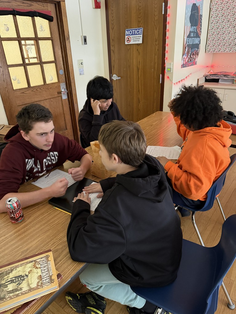four students at a desk