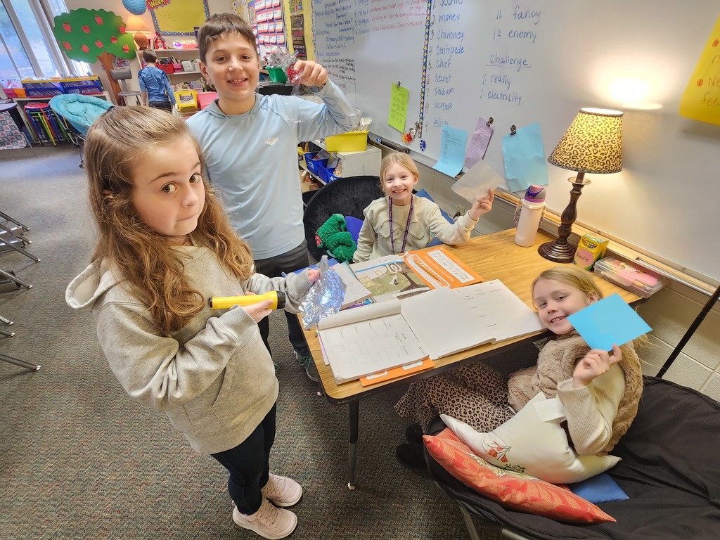 four student doing a light experiment