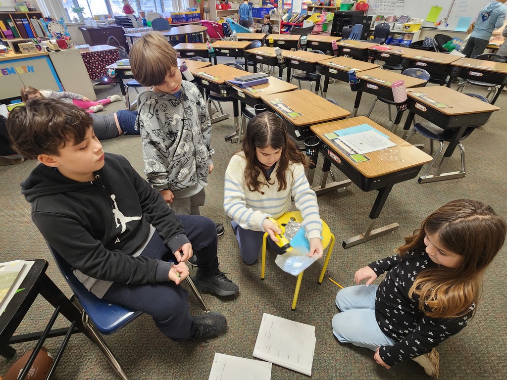 four student doing a light experiment