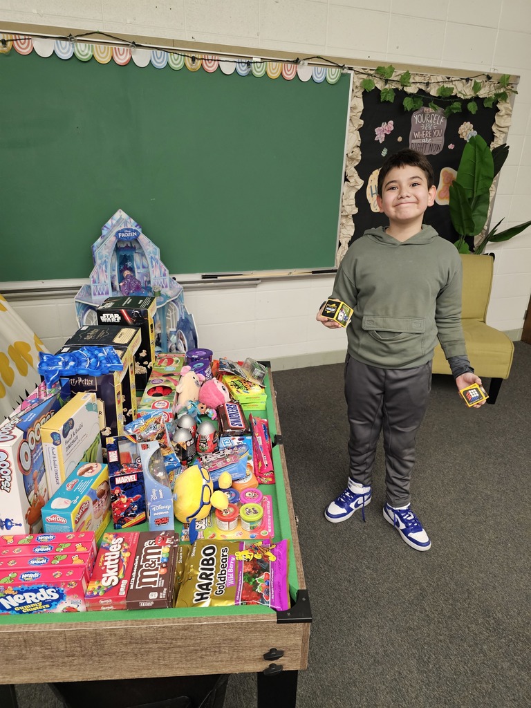 student by the prize table
