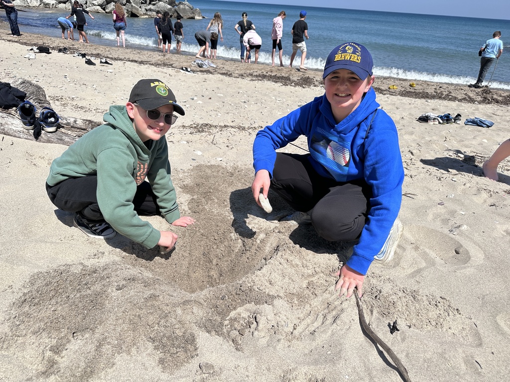 two students plaing in the sand of Lake Michigan