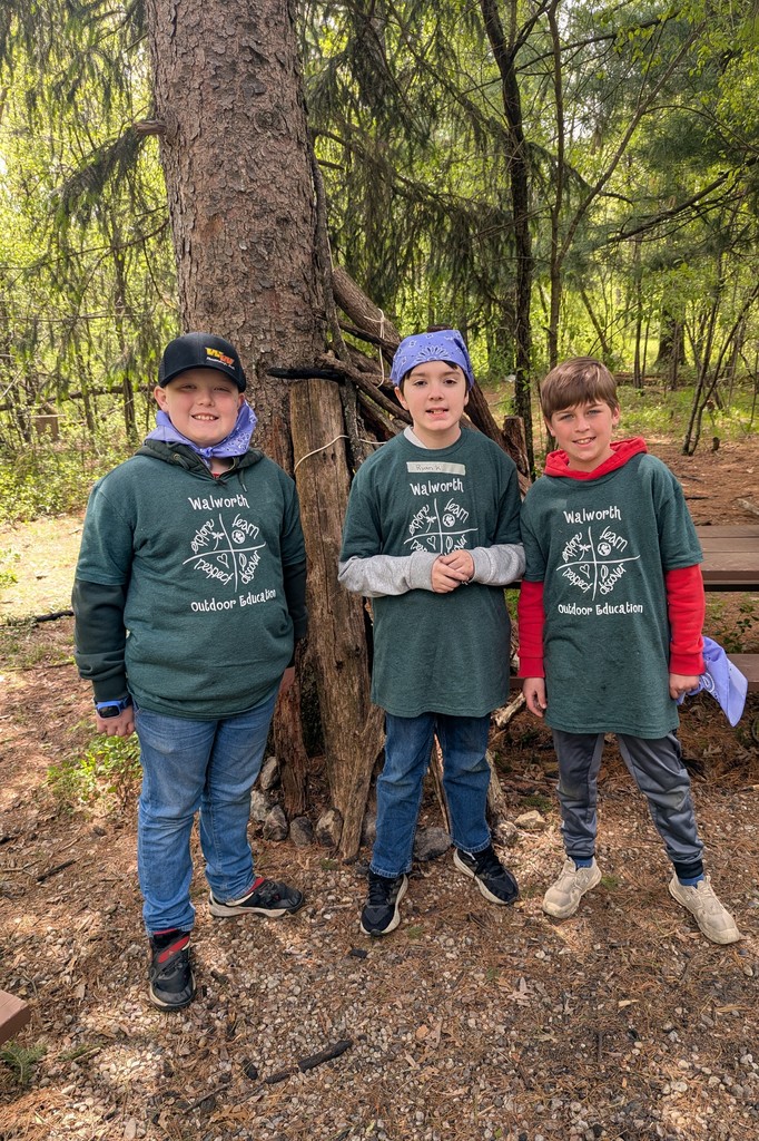 three students in the woods at camp