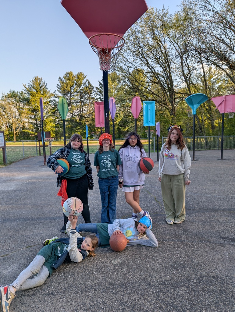 six students with basketball at camp