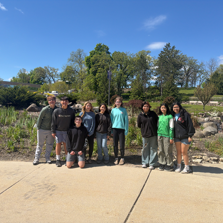 students in front of a rock wall