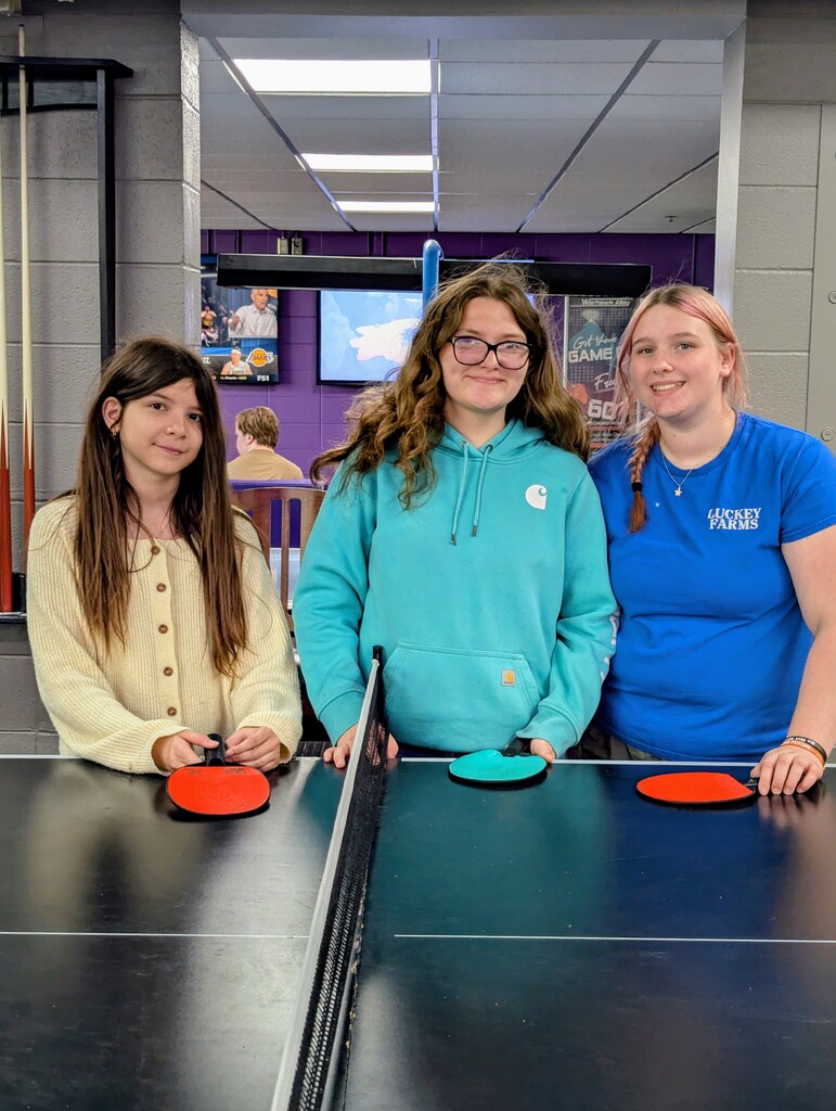 three students with ping-pong paddles