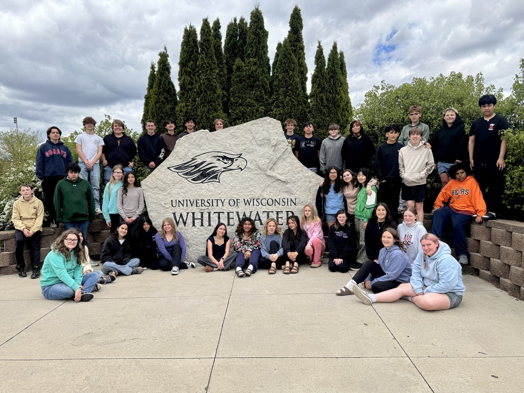 8th grade students in front of the UW Whitewater rock sign.