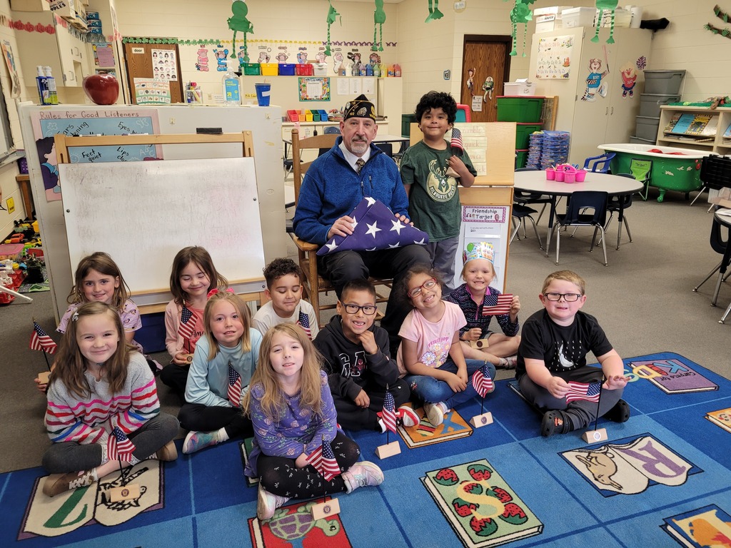 Mr. Kahl with kindergarten class and flag
