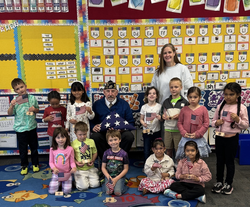 Mr. Kahl and kindergarten students with flag