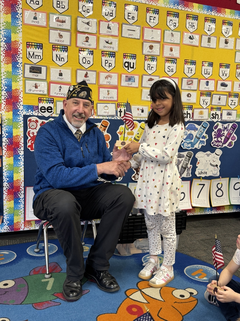 Mr. Kahl presenting flag to student