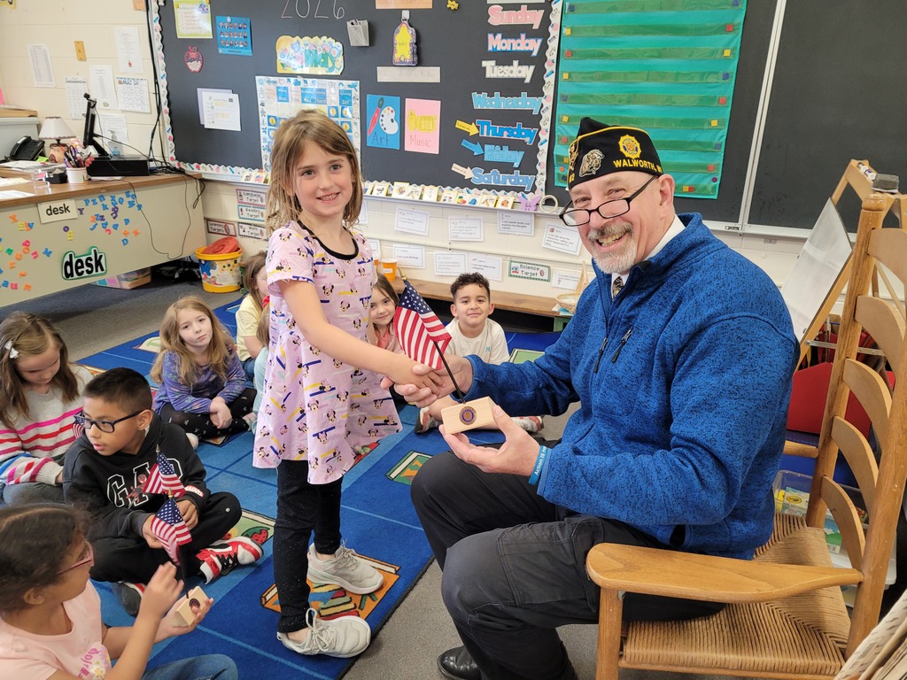 Mr. Kahl presenting flag to student