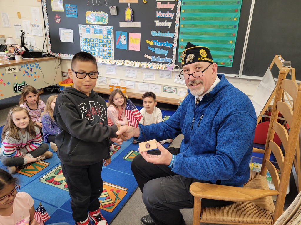 Mr. Kahl presenting flag to student