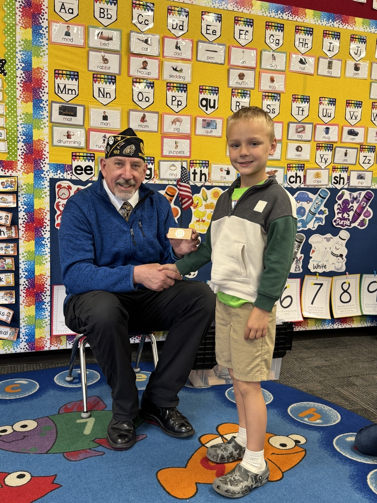 Mr. Kahl presenting a flag to a student