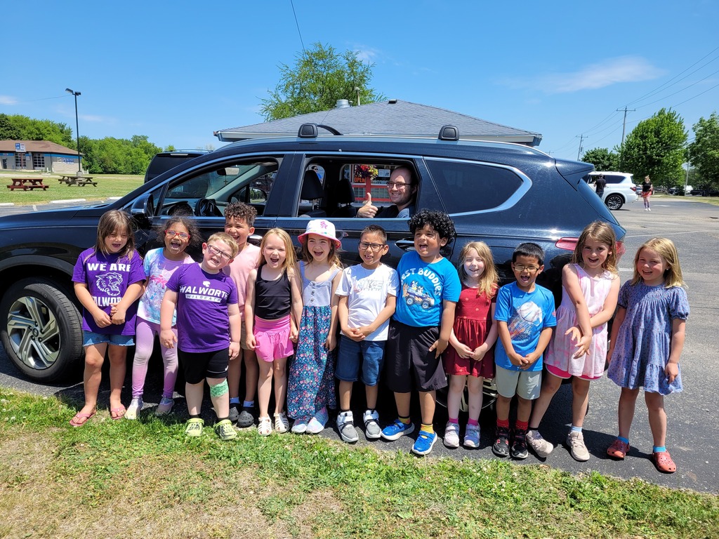 Students in front of a black car