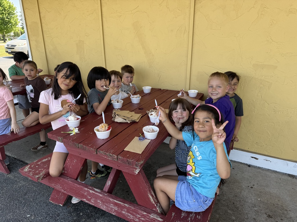 student eating ice cream on a red picnic table