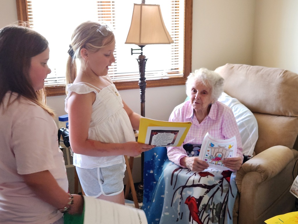 students sharing poems with resident of Golden Years