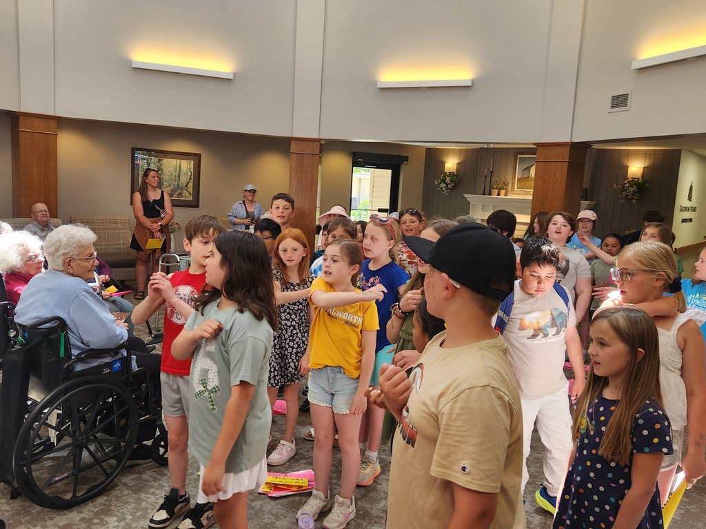 students sharing a song with resident of Golden Years