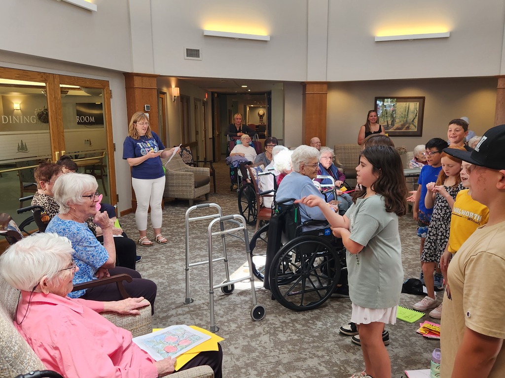 students sharing poems with resident of Golden Years
