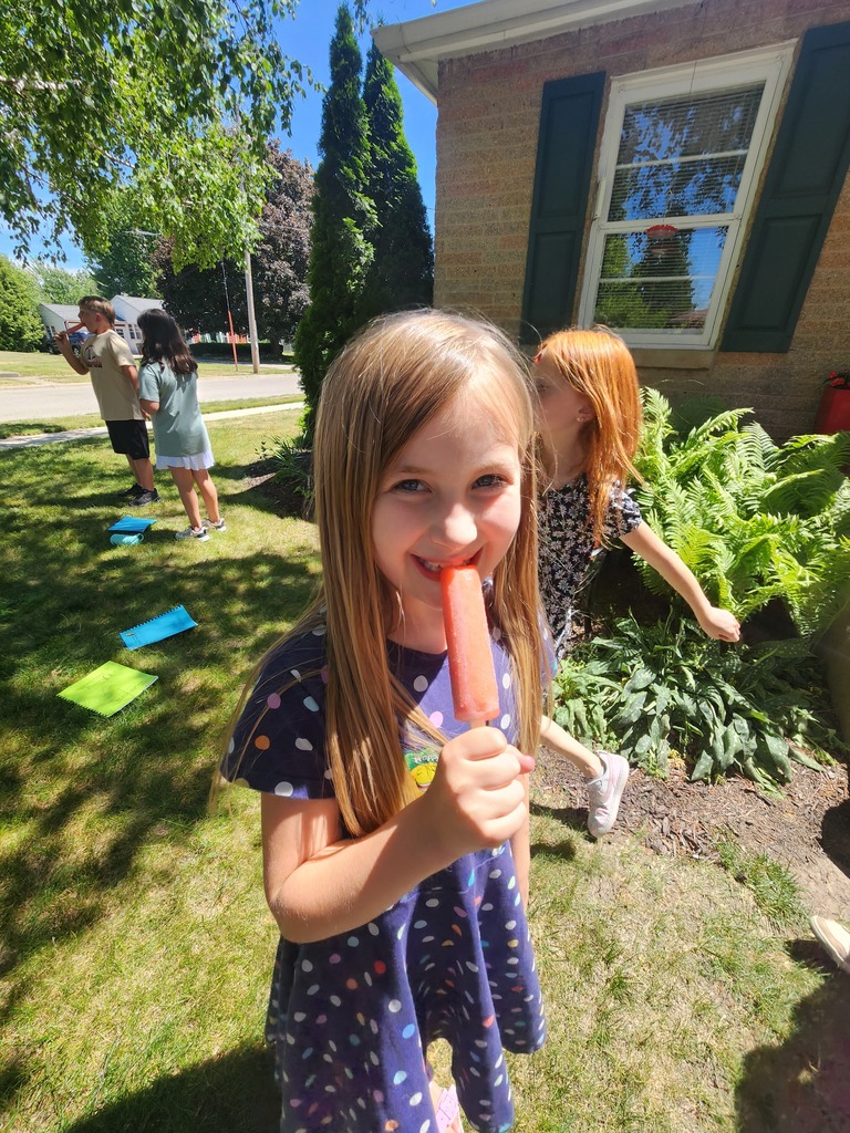 female student eating a popsicle