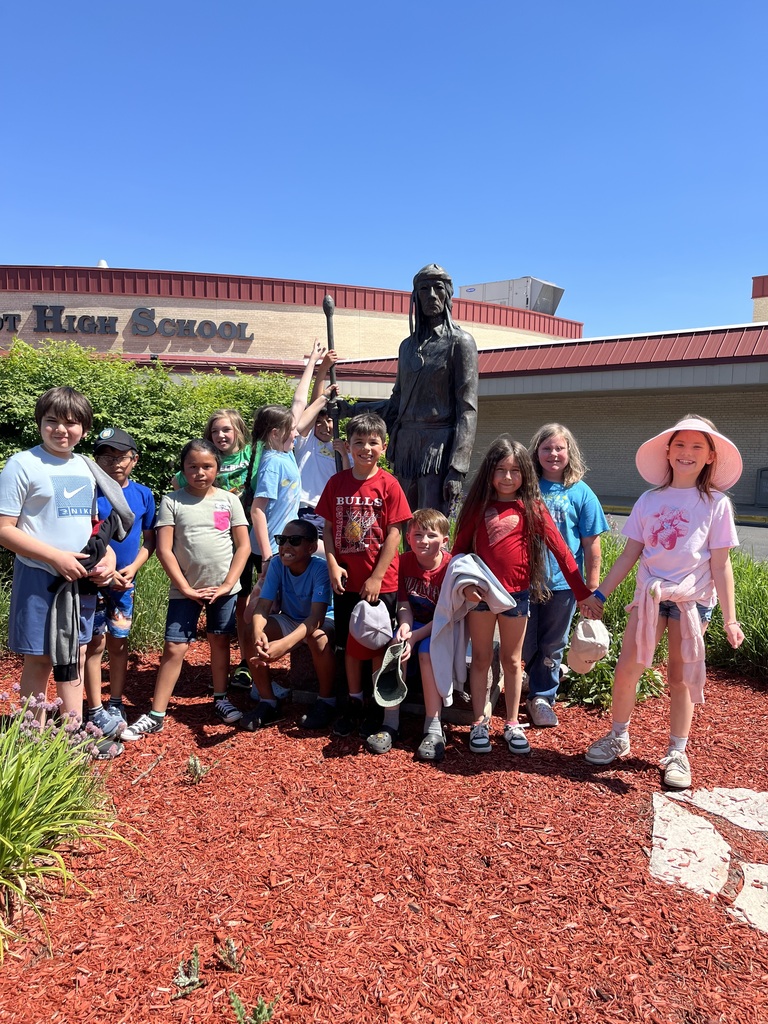 students in front of the big foot statue