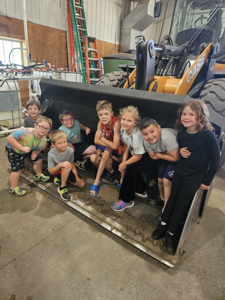 8 Students in a bulldozer scoop