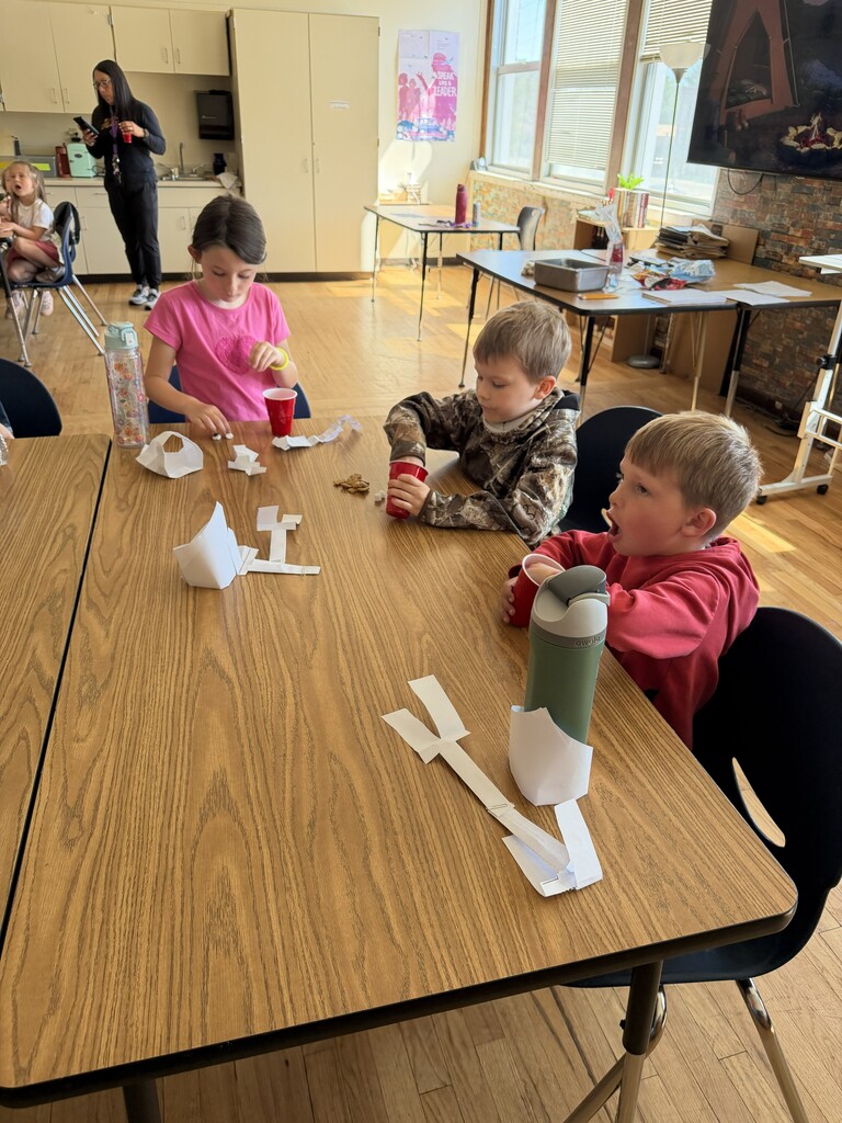 3 students working at a table