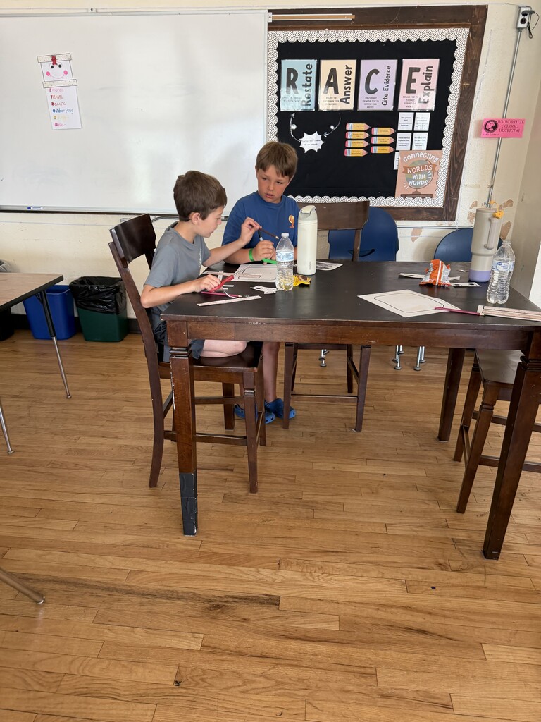 2 students working at a table