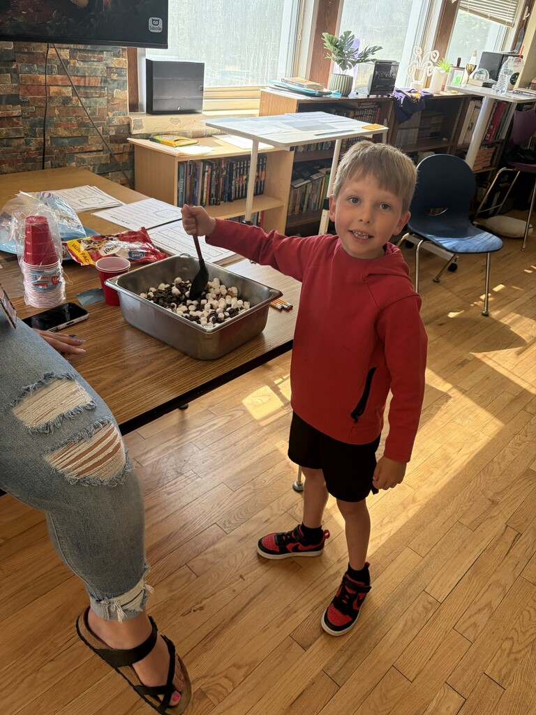 one student in a red sweatshirt with a box of snack items