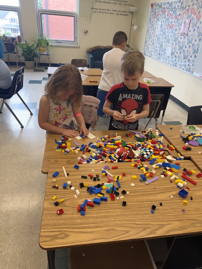 two student building with Legos