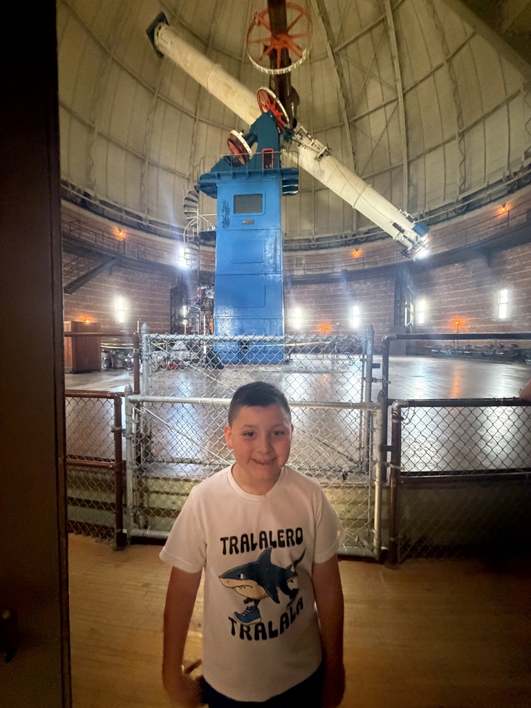 Student in front of the telescope at Yerkes Observatory.