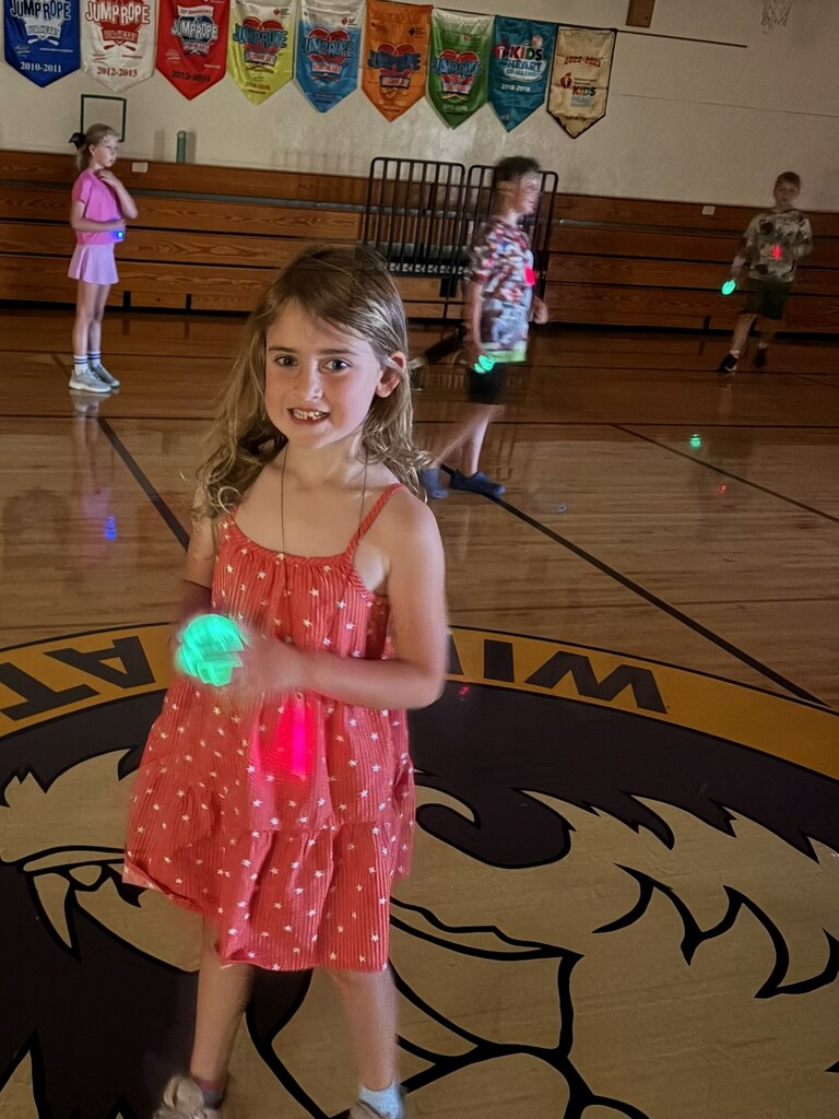 Student with green glow stick. 