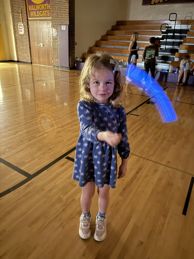 Student with blue glow stick. 