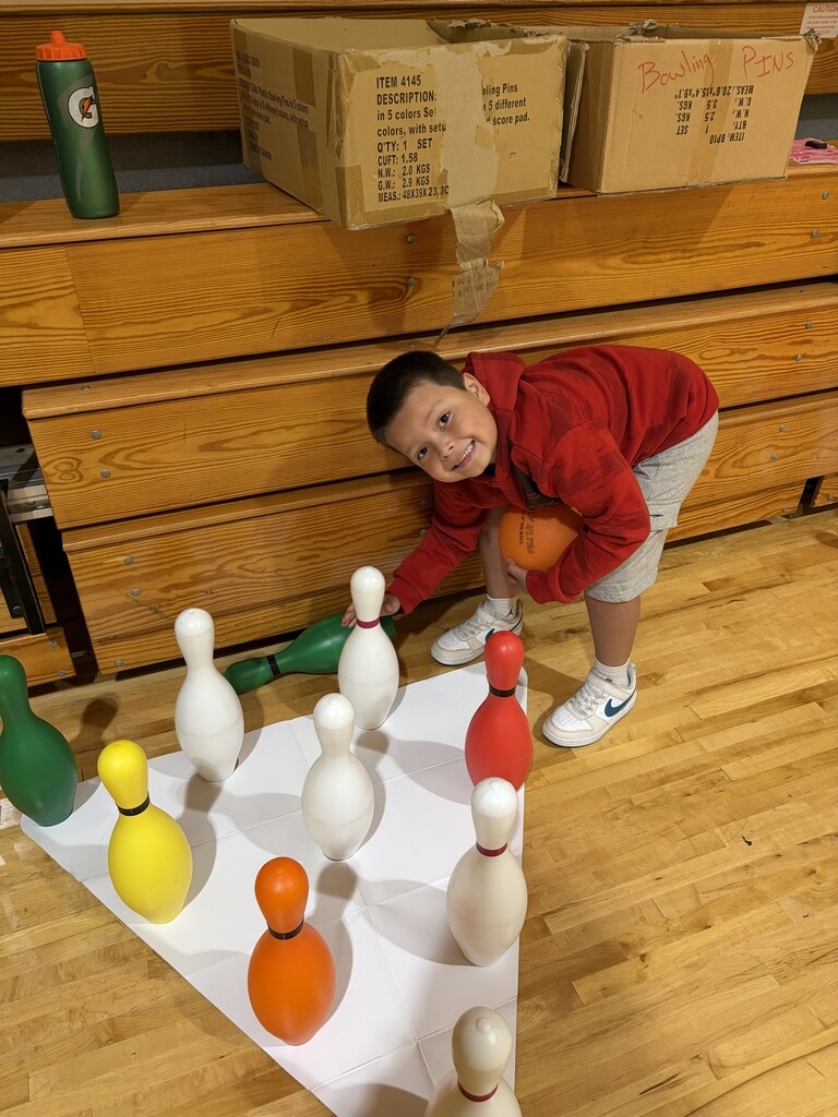 student setting up bowling pins
