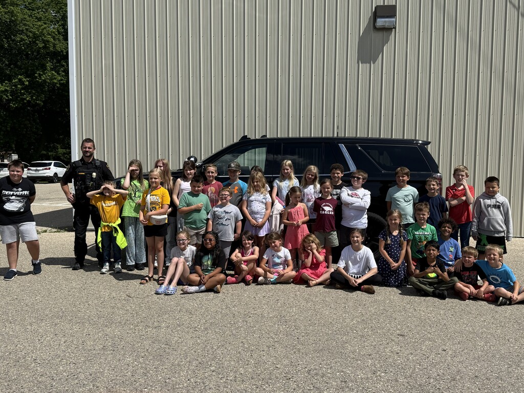 students in front of the police car