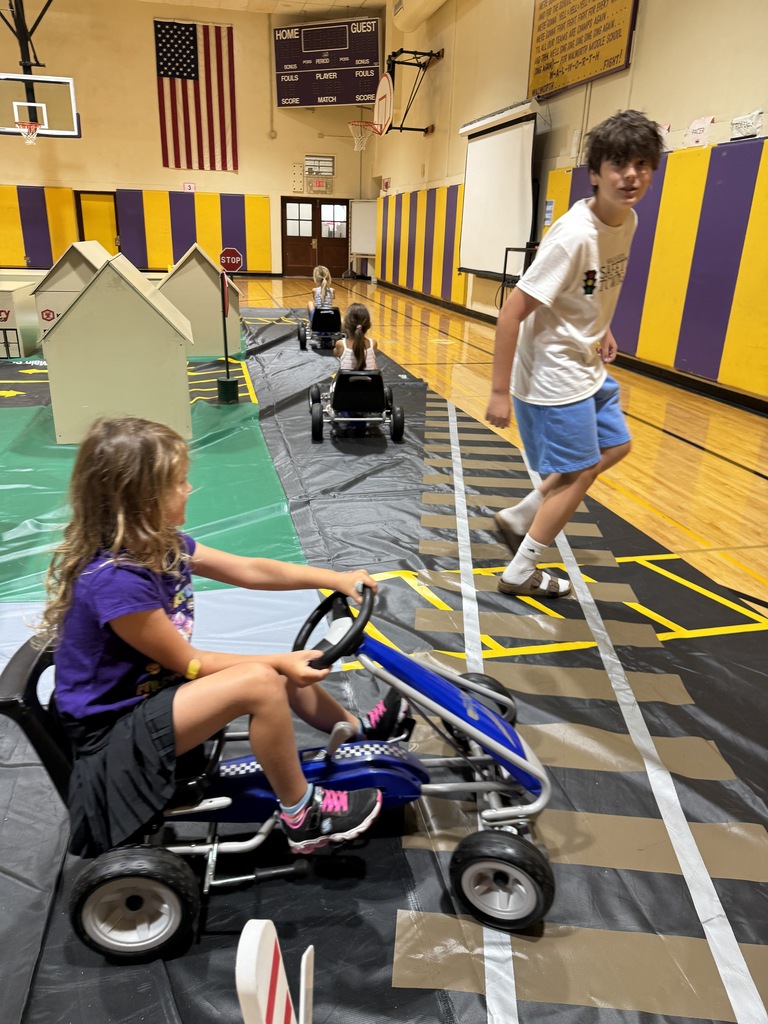 Student practicing safety rule in a pedal car. 