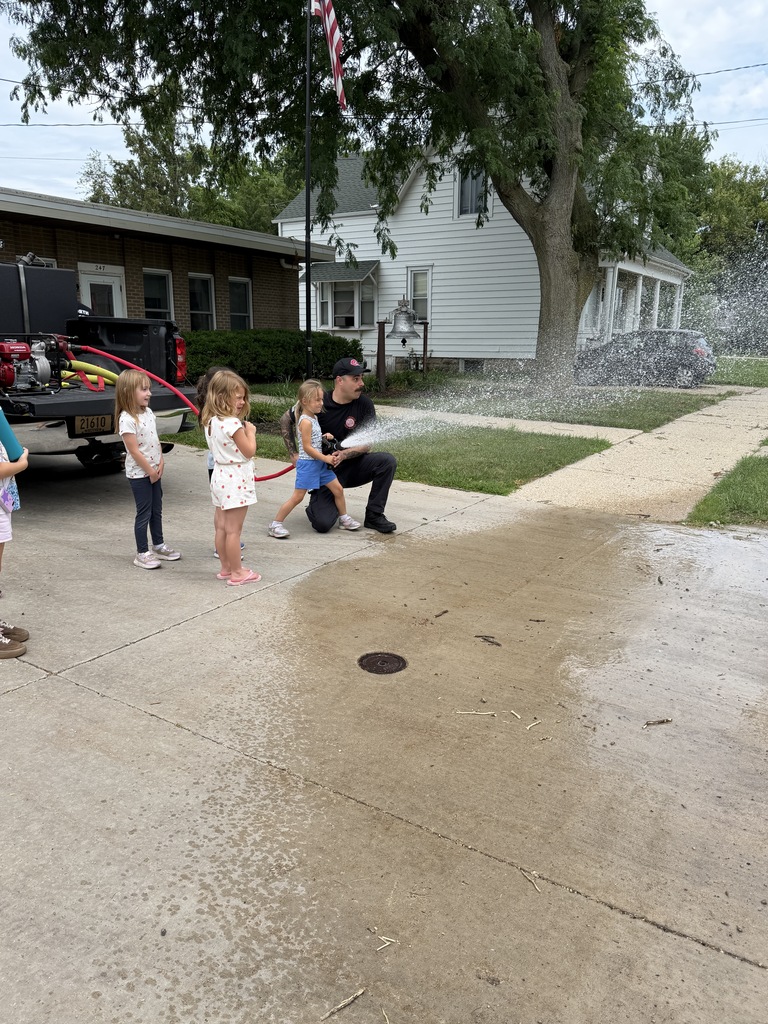 Students squirting the fire hose. 