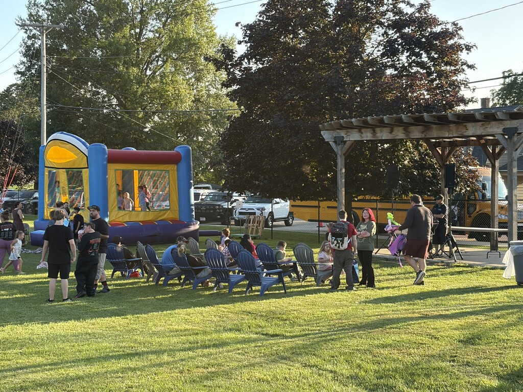 Jump house and many people in chairs