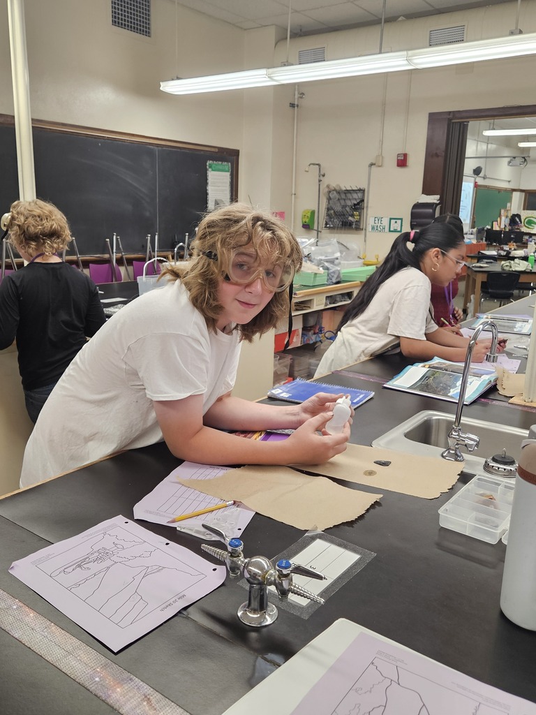 a student testing rocks