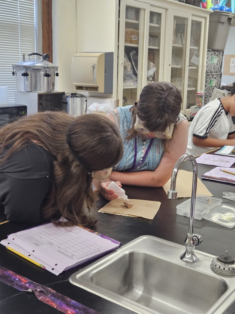 two students testing rocks