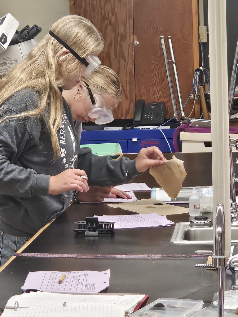 two students testing rocks