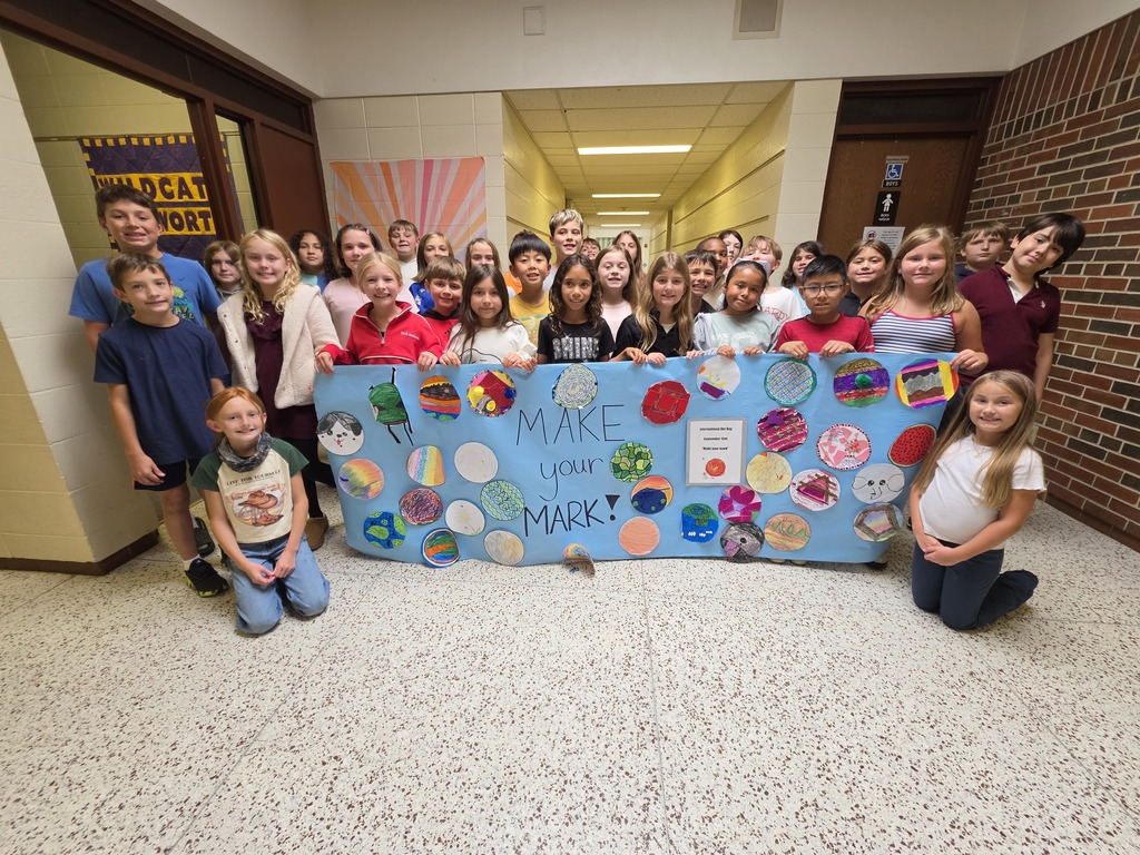 4th grade students with dots poster.