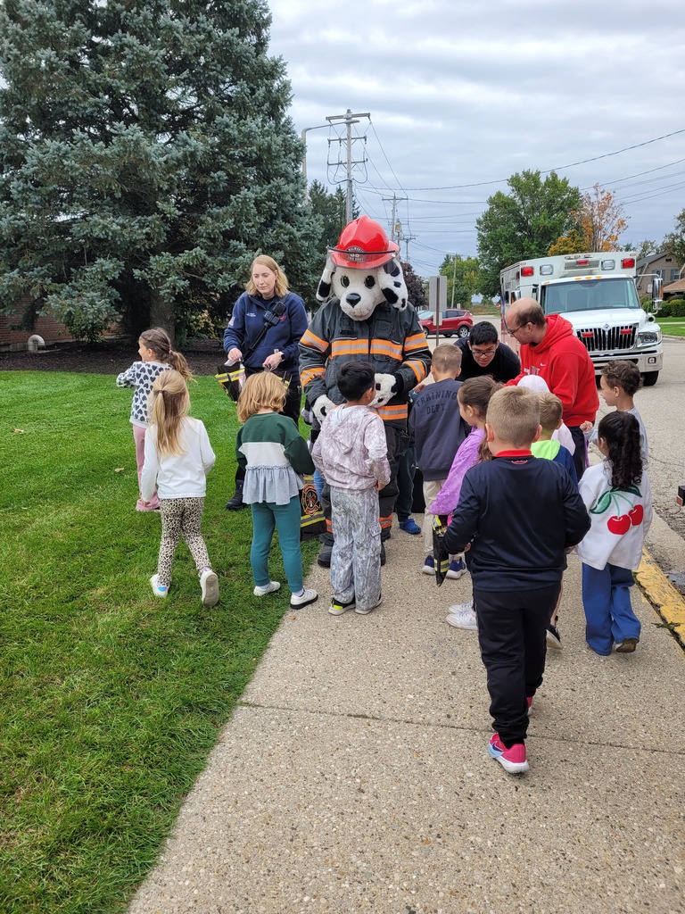 Sparky the fire dog and students.