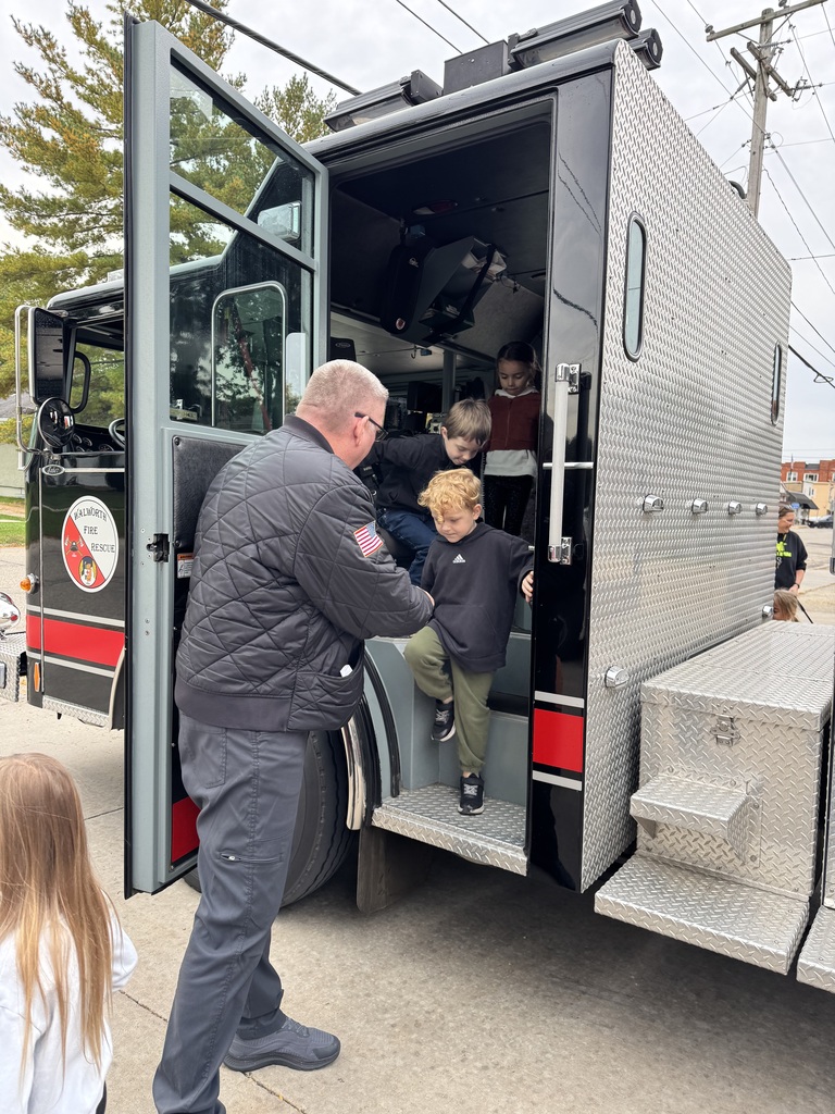 Students exiting a fire truck. 