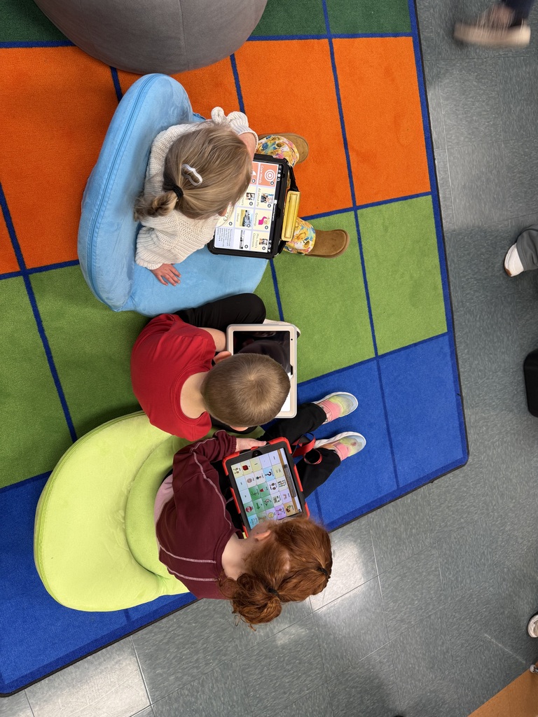 3 students using ipads