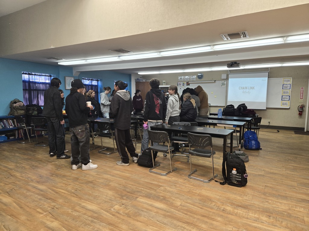 A State FFA Officer leading a communication workshop with Warner FFA members standing in a classroom.