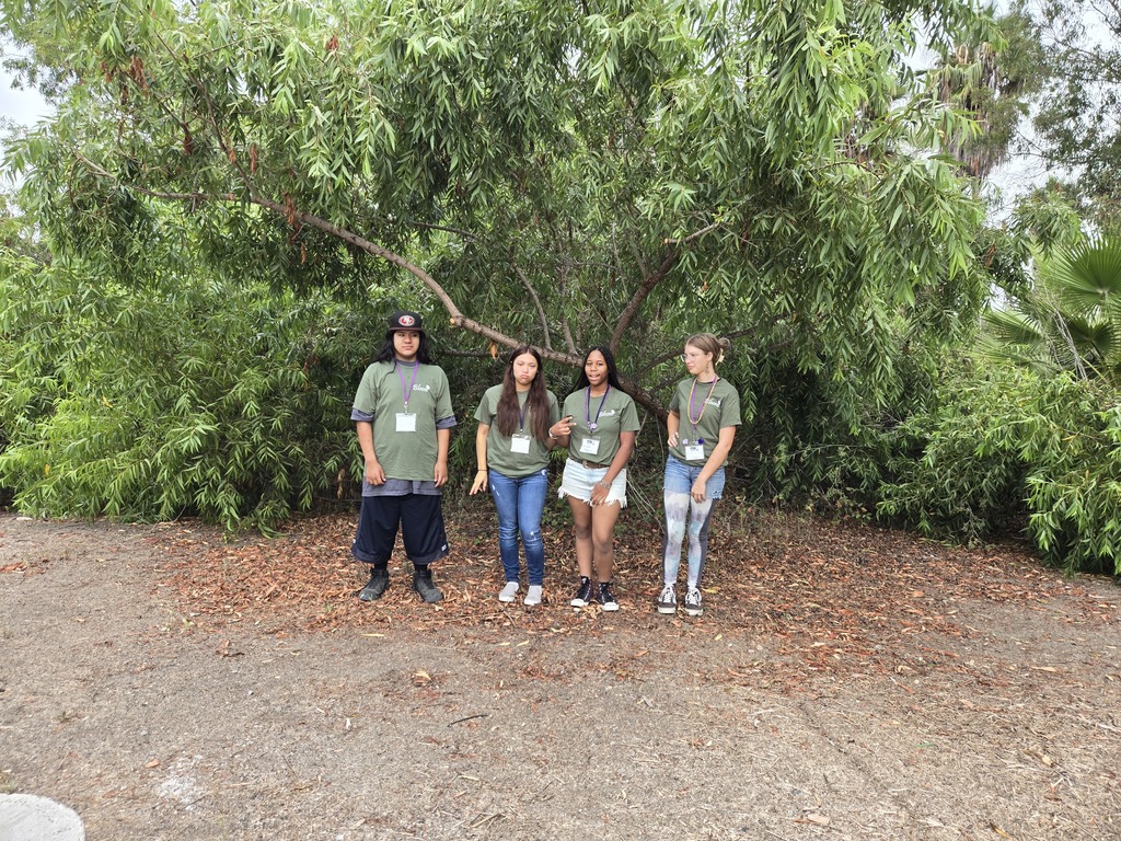 Four Warner students posing together before their SLC conference.