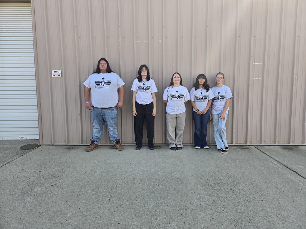 Five Warner FFA students wearing white Greenhand shirts posing together before their event