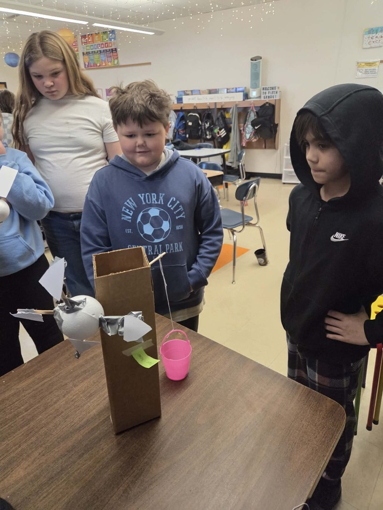 Fifth graders are learning the engineering design process and how to use Earth's resources wisely by construction their own windmills! Each group had a successful windmill able to lift a weighted bucket.