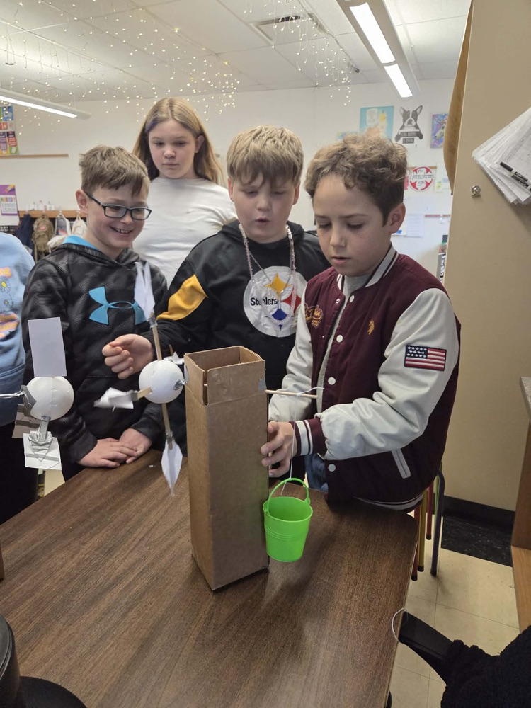 Fifth graders are learning the engineering design process and how to use Earth's resources wisely by construction their own windmills! Each group had a successful windmill able to lift a weighted bucket.