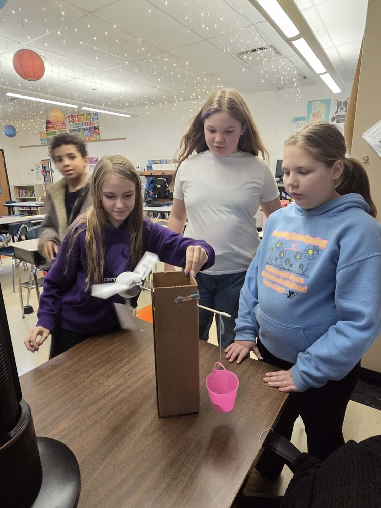 Fifth graders are learning the engineering design process and how to use Earth's resources wisely by construction their own windmills! Each group had a successful windmill able to lift a weighted bucket.