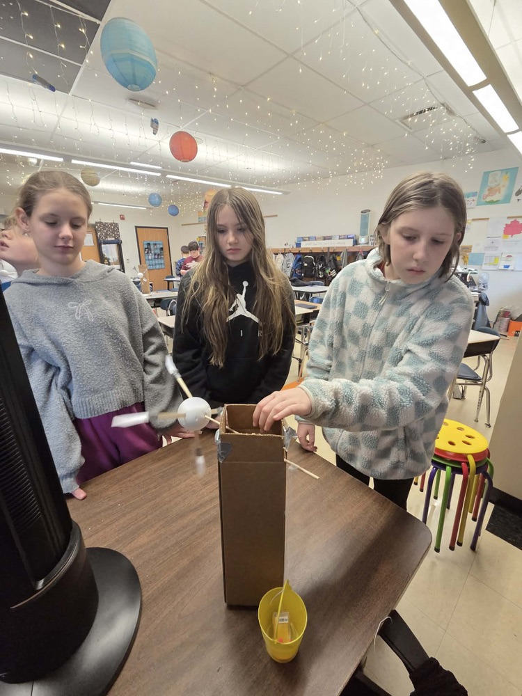 Fifth graders are learning the engineering design process and how to use Earth's resources wisely by construction their own windmills! Each group had a successful windmill able to lift a weighted bucket.